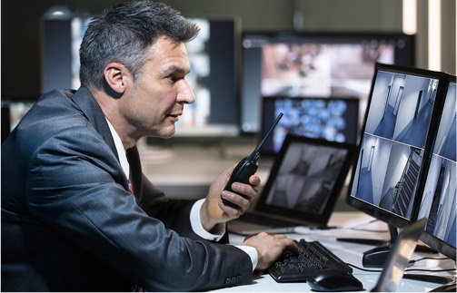 Security looking at computer