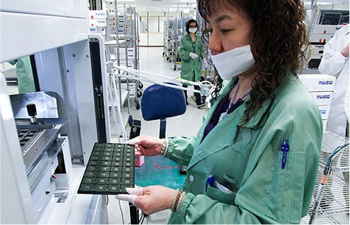 Semiconductor Backend Services woman checking chips